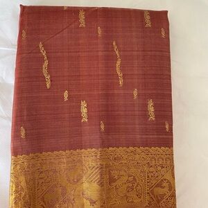 Kanchi silk saree beautiful Sandal wood color. Gold butta all over.